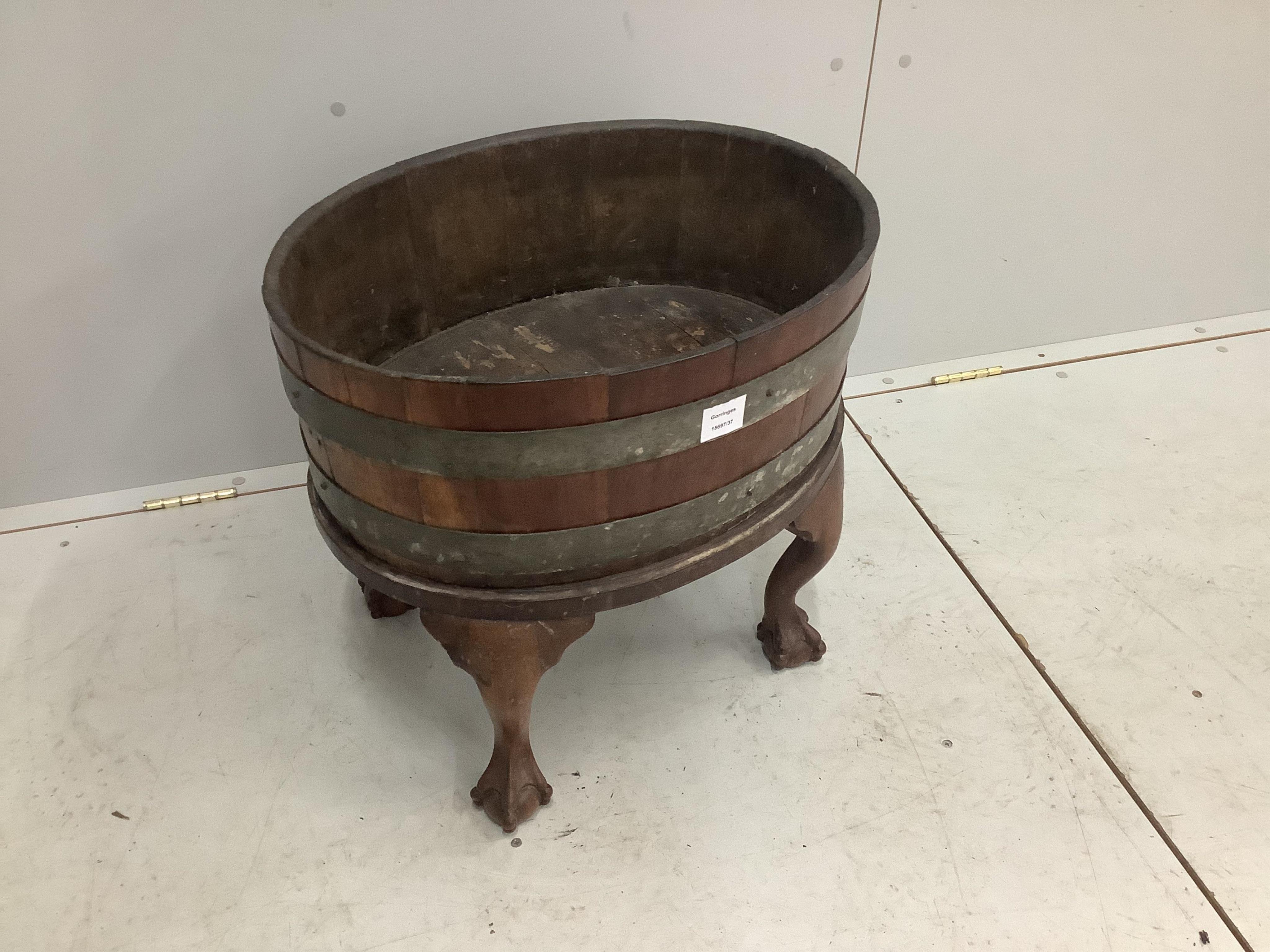 A George III oval brass bound mahogany wine cooler, width 54cm, depth 42cm, height 49cm. Condition - fair